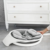 Baby seat with a white base in a room setting